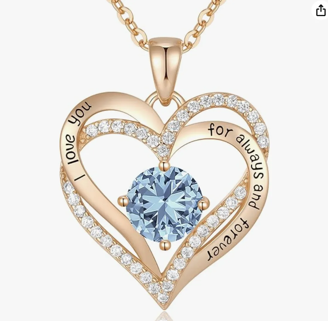 Close-up of a gold double-heart pendant necklace, featuring a brilliant light blue center stone, pave diamond accents, and an engraving that reads 'I love you for always and forever'.