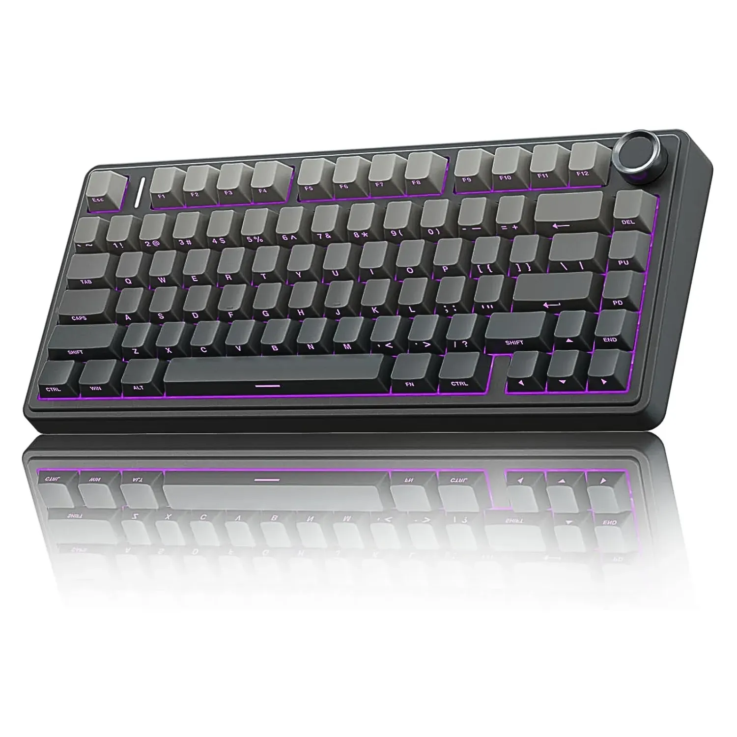 Angled close-up of a sleek, dark grey compact mechanical keyboard with contrasting grey keycaps, vibrant purple backlighting, and a silver rotary control knob in the top-right corner, shown with its reflection