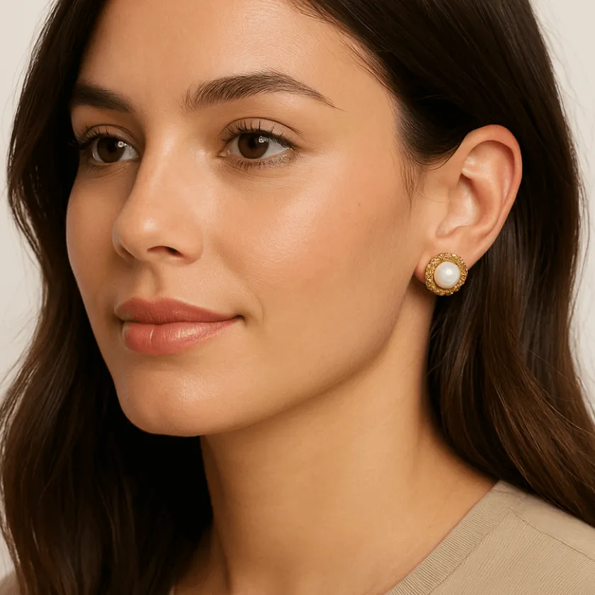 A close-up of a woman wearing elegant gold and pearl stud earrings, showcasing a natural look with soft makeup and a subtle smile, styled as an AI fashion model promoting luxurious accessories.